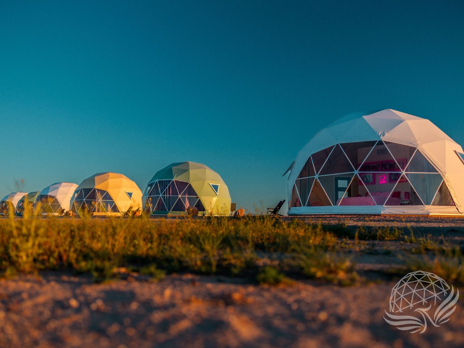 Geodesic domes lit from inside at dusk